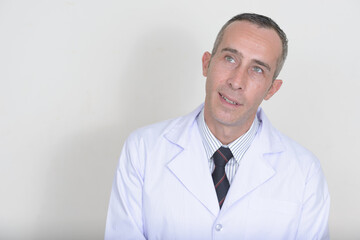Portrait of mature handsome man doctor against white background
