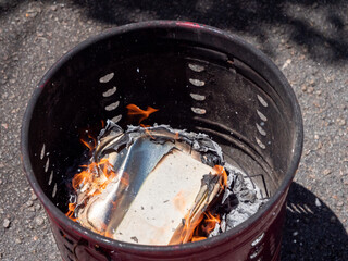 Silver Chinese joss paper being burnt for ancestral worship or prayer purposes