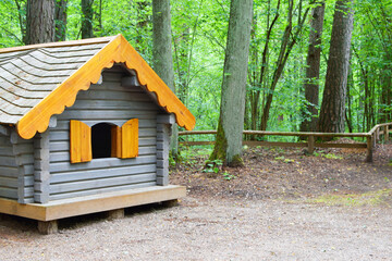 Little wooden decorative house in park or forest.
