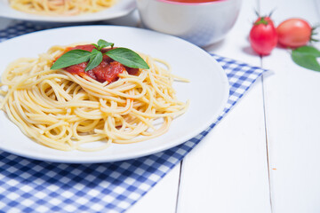Spaghetti pasta with and tomato sauce on wood background