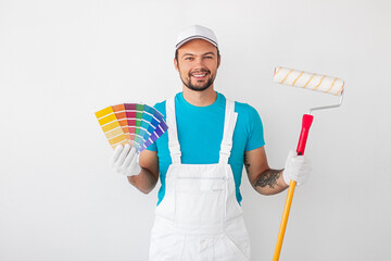 Cheerful painter with paint roller and palette