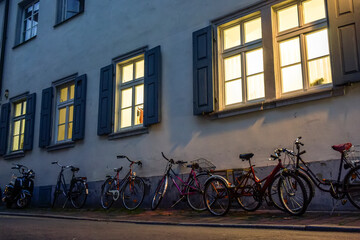 Fototapeta na wymiar Bicycles parked on narrow medieval street with traditional Bavarian houses in Bamberg, Bavaria, Germany. November 2014