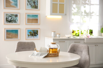 Fototapeta na wymiar Stylish kitchen interior with teapot and cups on table