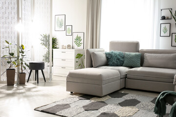 Comfortable large sofa in light room. Interior design