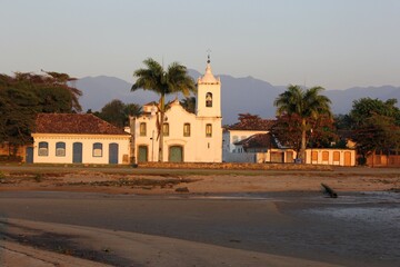 Fototapeta na wymiar Ancient white church by the sea in colonial style. Paraty city, Brazil.