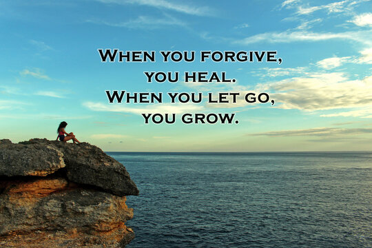Inspirational quote - When you forgive, you heal. When you let go, you grow. On blurry background of bright blue sky over horizon and a young woman sitting alone on rock against ocean view.