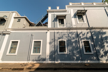 Grey walls and rectangular windows of old French architecture in the city of Pondicherry in South India.