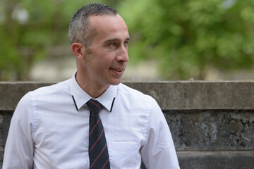 Portrait of happy mature handsome businessman outdoors