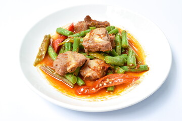 spicy fried pork bone with slice yard long bean in curry sauce on plate 
