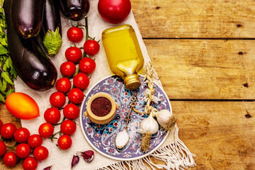 A set of products for the preparation of a traditional Turkish dish Imam Bayildi on old wooden table