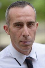 Obraz premium Portrait of mature handsome businessman with gray hair outdoors