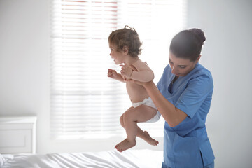 Orthopedist examining cute little baby in office