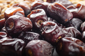 Pile of dried dates fruits on kitchen table. Healthy nutritious antioxidant natural sweeteners