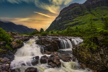 Fototapeta na wymiar Waterfalls at sunrise in Glencoe, highlands, Scotland.