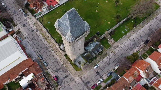 Aerial drone view of old Water Tank tower building called Torre Tanque - one of popular city landmark. Drone fly around old tower. Mar del Plata, Argentina.
