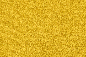 Fototapeta premium Yellow natural cotton towel background, close-up yellow towel texture.