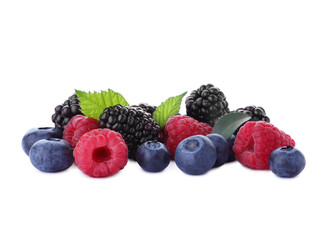 Pile of different ripe tasty berries with green leaves isolated on white