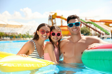 Happy family in swimming pool. Summer vacation