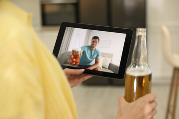 Friends having video chat and drinking beer together. Online meeting during coronavirus quarantine