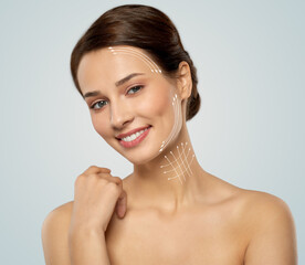 cosmetology, plastic surgery and beauty concept - beautiful smiling young woman face with massage...