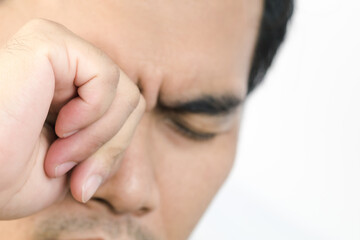Fototapeta premium Asian young man is rubbing his eyes with concepts 