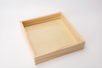 Square wooden tea tray against a white background