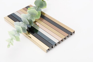 The metal and steel frames made of different materials are neatly arranged with a green plant on top.