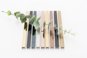 The metal and steel frames made of different materials are neatly arranged with a green plant on top.