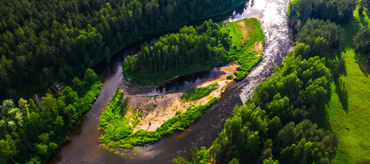 Top drone landscape of summer forest and the river. Green trees. Beautiful latvian nature.