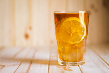 Glasses of ice tea with lemon slices  on wooden background