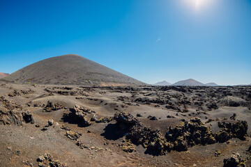 Volcanic landscape with volcano, lava stones and rocks at Lanzarote