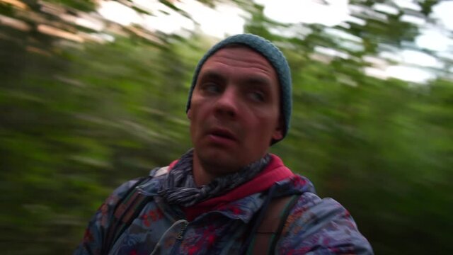 A man with dizziness and blurred consciousness is walking in a city park. Head banging on a tree. Forest fruit poisoning.
