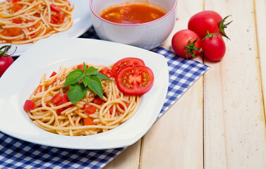 Spaghetti pasta with and tomato sauce on wood background