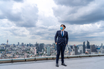 Young businessman wear masks to prevent dust and toxic pollution from the air, smoke and viral diseases,Perspectives on the future and success