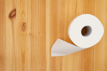 Toilet paper roll on a wood table