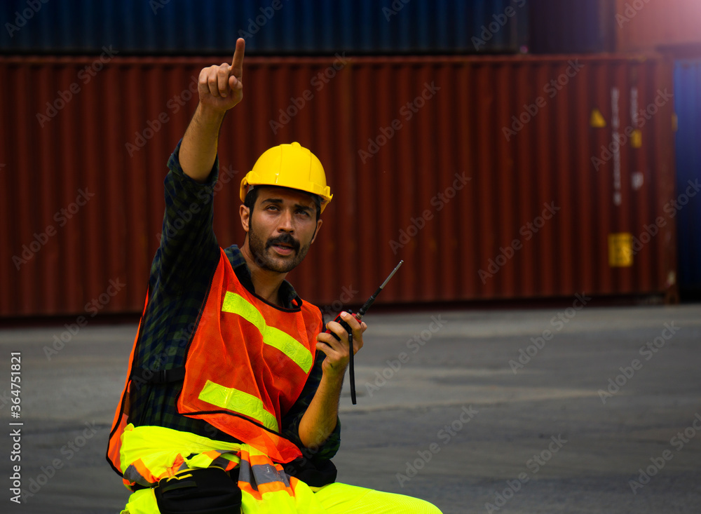 Aufkleber industrial worker is controlling container loading in import-export business.