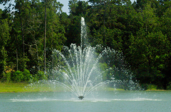 Water fountain in a neighborhood pond in Conroe, TX. - Powered by Adobe