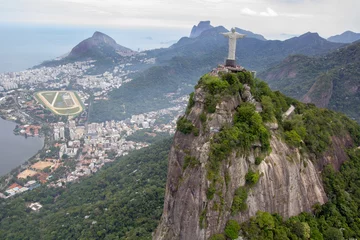 Fotobehang Aerial shot of the amazing Rio de Janeiro's cityscape with visible statue of Christ the Redeemer © Fernando Valle/Wirestock