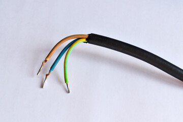 Three wires (plus, minus and earthing). Three-wire electric wire. The power cable is cut, with the...