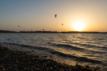 Kiters gliding over the Red sea surface. Extreme outdoor sport/activity/recreation. People in sport...