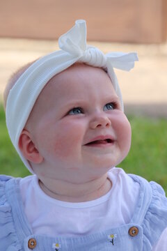 Baby girl seven months old full face image blue eyes blonde hair 