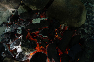 Hot coals from a campfire for cooking