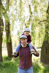 Father and son walk in park