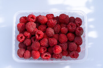 Ripe raspberries on a white background