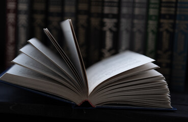 Open book on the background of books