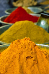 Turmeric curcuma powder and chili powder in spices market in India. Sardar Market, Jodhpur, Rajasthan, India