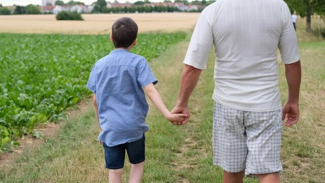 family, man and children walk among meadows and forests in summer, the concept of family summer vacations, picnics, vacations, camping, activity in the park