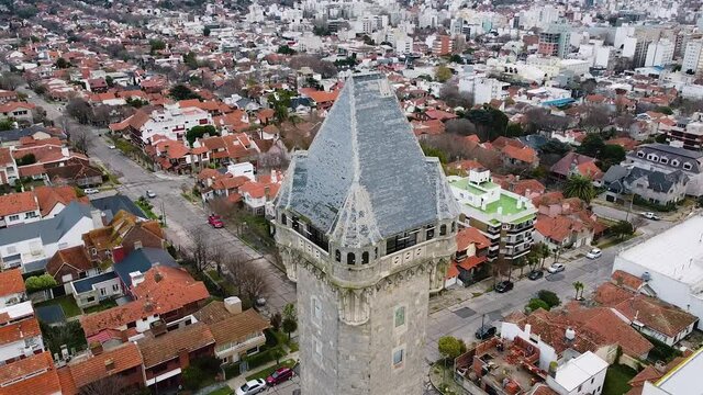 Aerial drone view of old Water Tank tower building called Torre Tanque - one of popular city landmark. Drone fly above old tower. Mar del Plata, Argentina.
