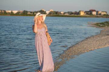 woman on the beach. woman on the beach at sunset. young woman in white dress on the beach