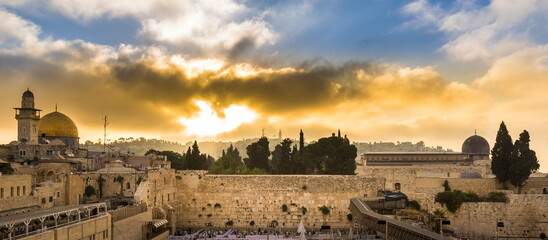 Beautiful sunrise clouds over the Mount of Olives and the Temple Mount sites: Dome of the Rock,...